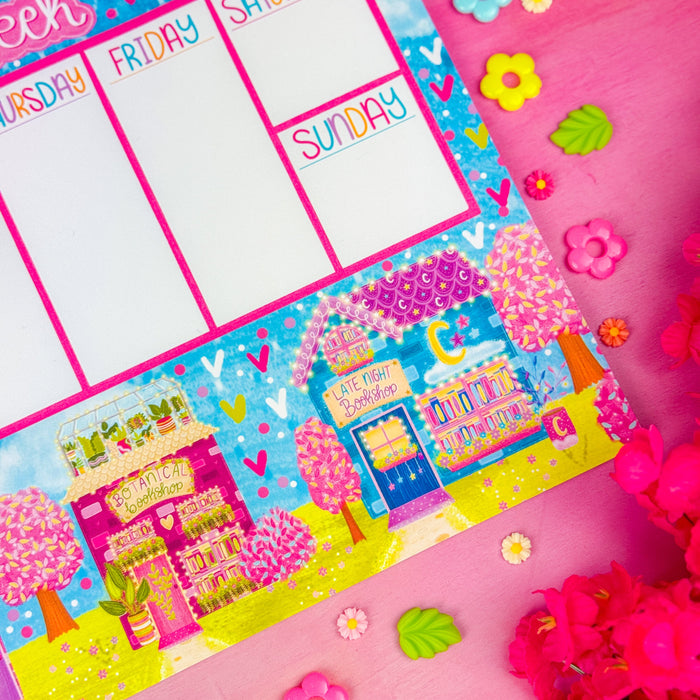 A detail view of a weekly planner notepad with "this week" at the top and 3 spring themed bookshops along the bottom.