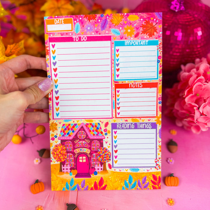 A notepad with sections for a to do list, important items, notes, and reading things. Featuring a fall bookshop in the lower left corner and leaves along the top.