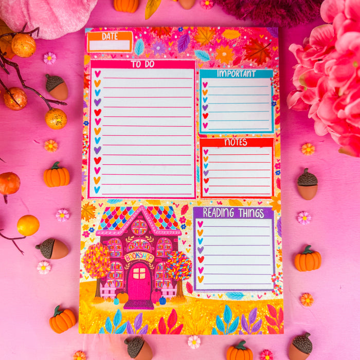 A notepad with sections for a to do list, important items, notes, and reading things. Featuring a fall bookshop in the lower left corner and leaves along the top.