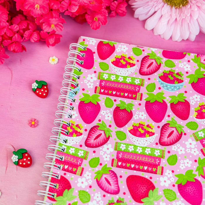 Notebook with strawberry pattern on a pink background with flowers