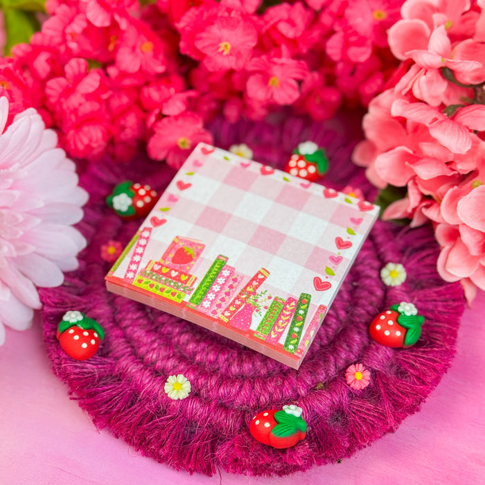 Small strawberry sticky notes with strawberry decorations on a pink floral background